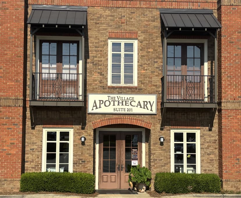 Smiling pharmacist helping customer